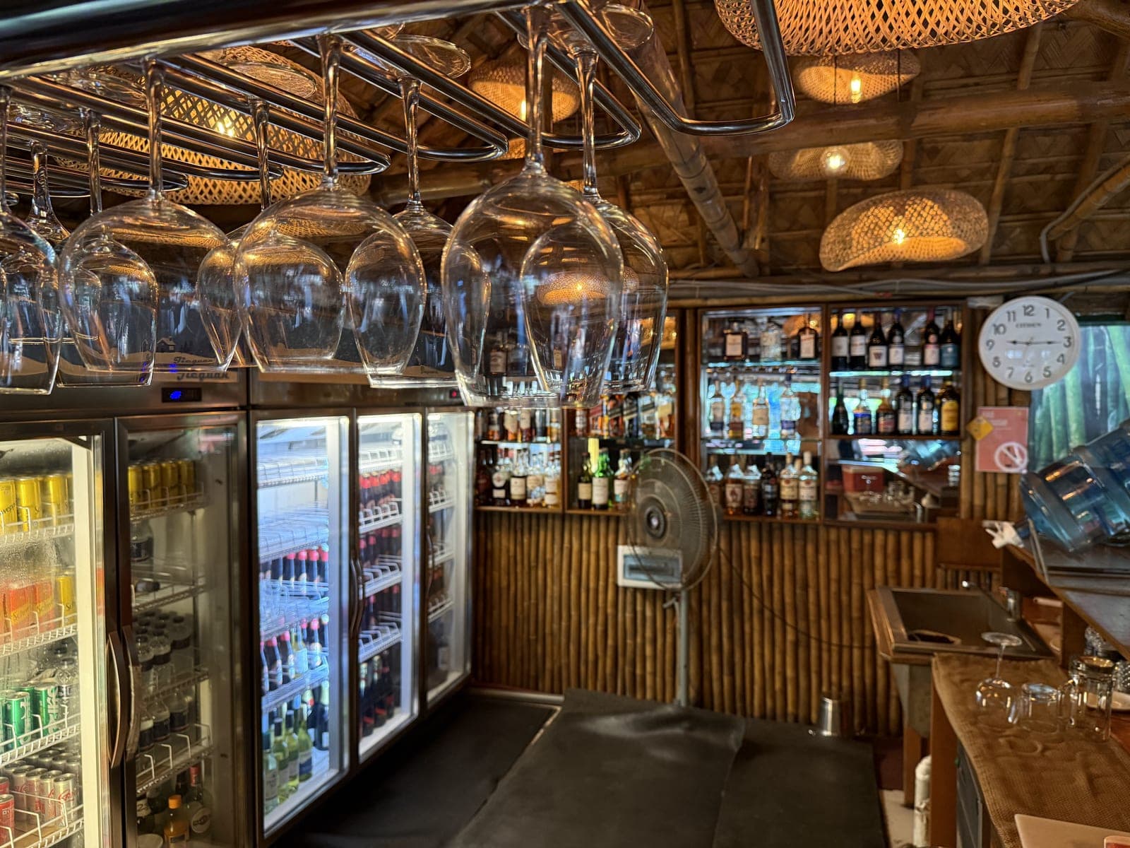 The club bar, with hanging glasses and a wide drinks selection