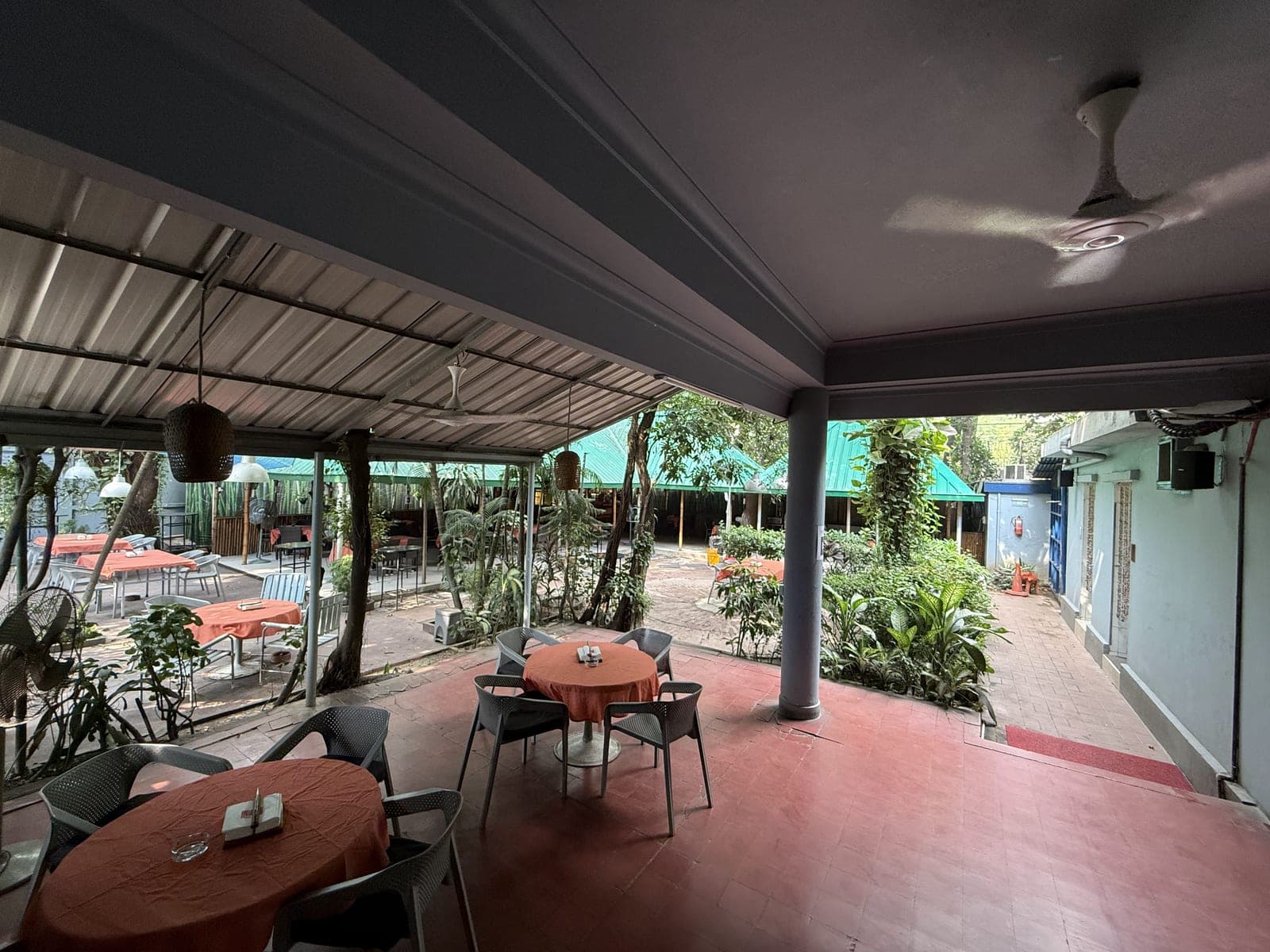 The covered garden café of the Dutch Club, set for lunch