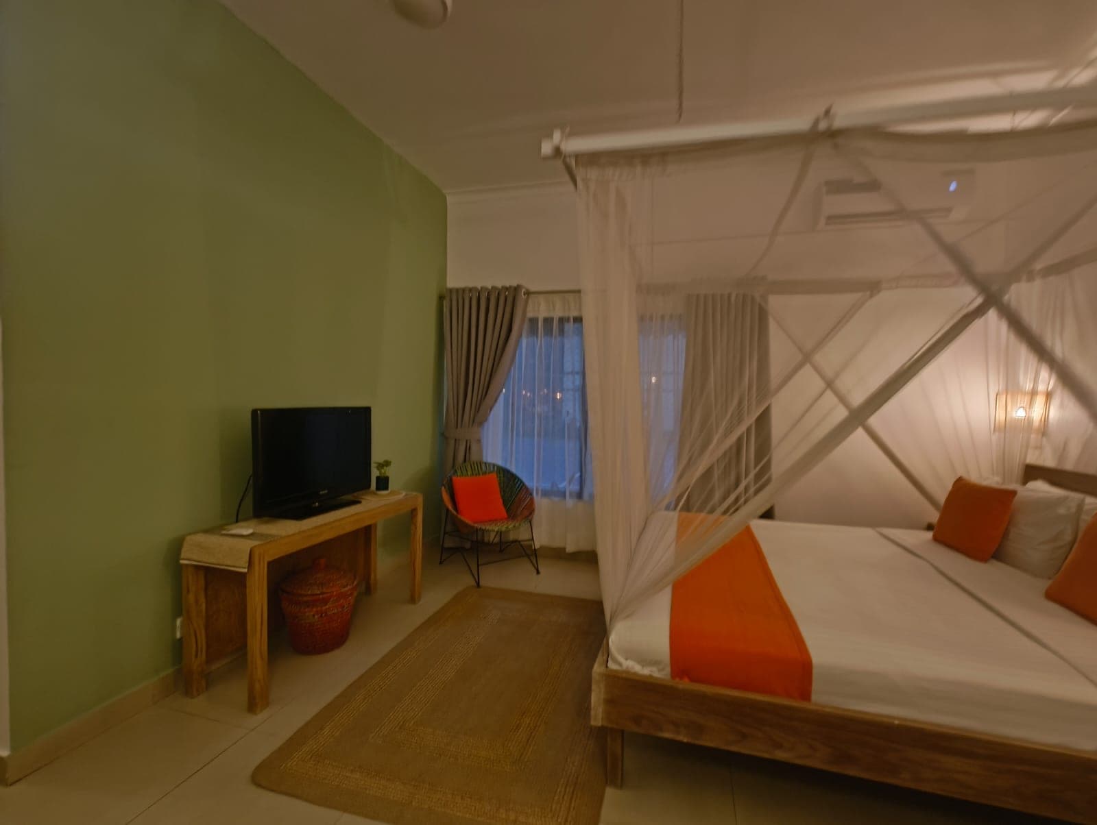 A guest room with a canopy bed at the Dutch Club guest house